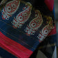 Black chanderi silk saree with thin golden zari border and geometrical shape in border with combination of red and white heavy work in pallo